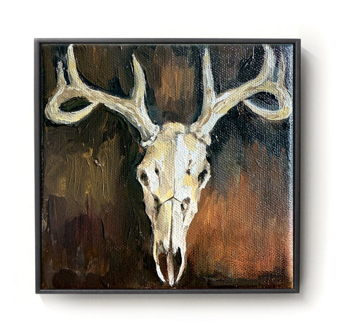 Framed painting of a deer skull with antlers on a dark background